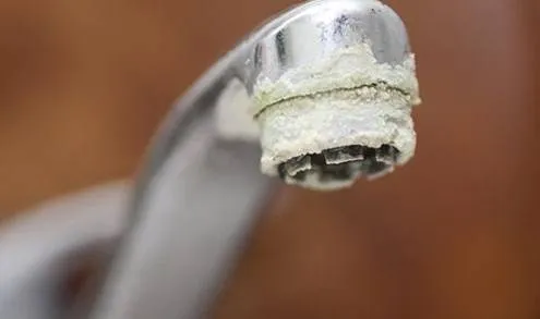 crusty calcium buildup corrosion on sink faucet