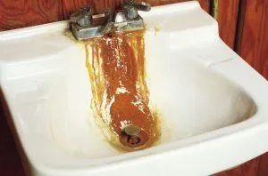 Rusty stain running from faucet to drain in bathroom sink