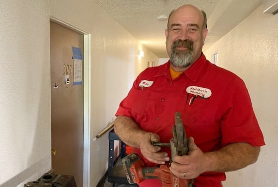 Fletcher's technician, Mike, with drill in hallway.