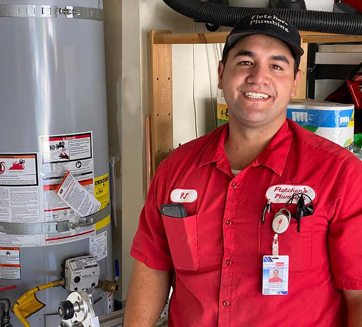 Fletcher's technician standing by water heater