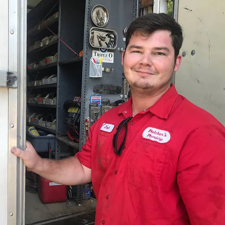 Plumber standing by open door at the back of the truck