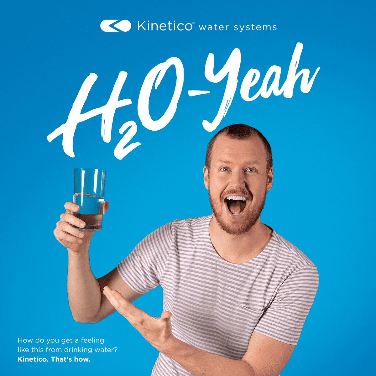 Very happy man holding and pointing to a glass of water