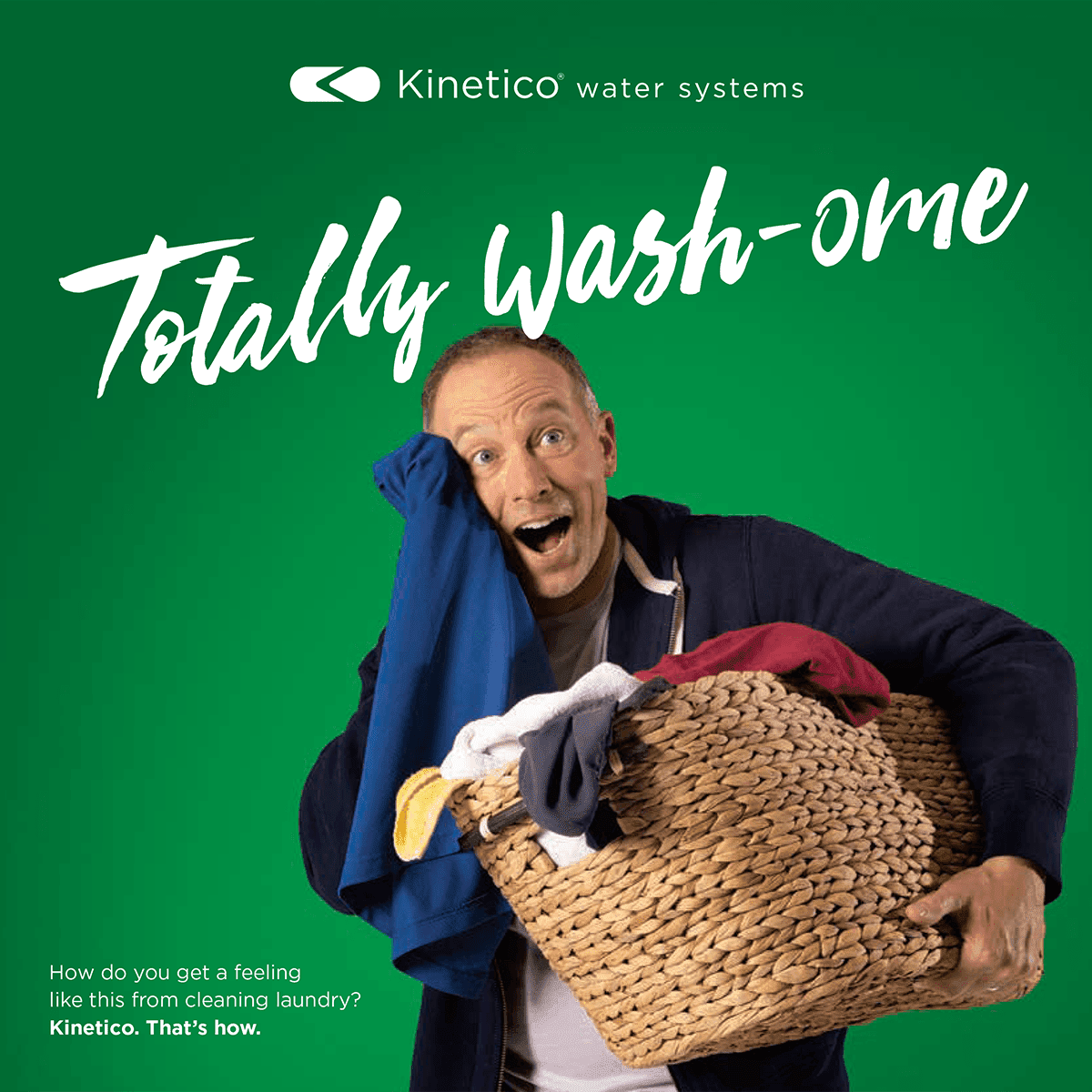 happy man holding laundry basket while wiping soft towel on his face