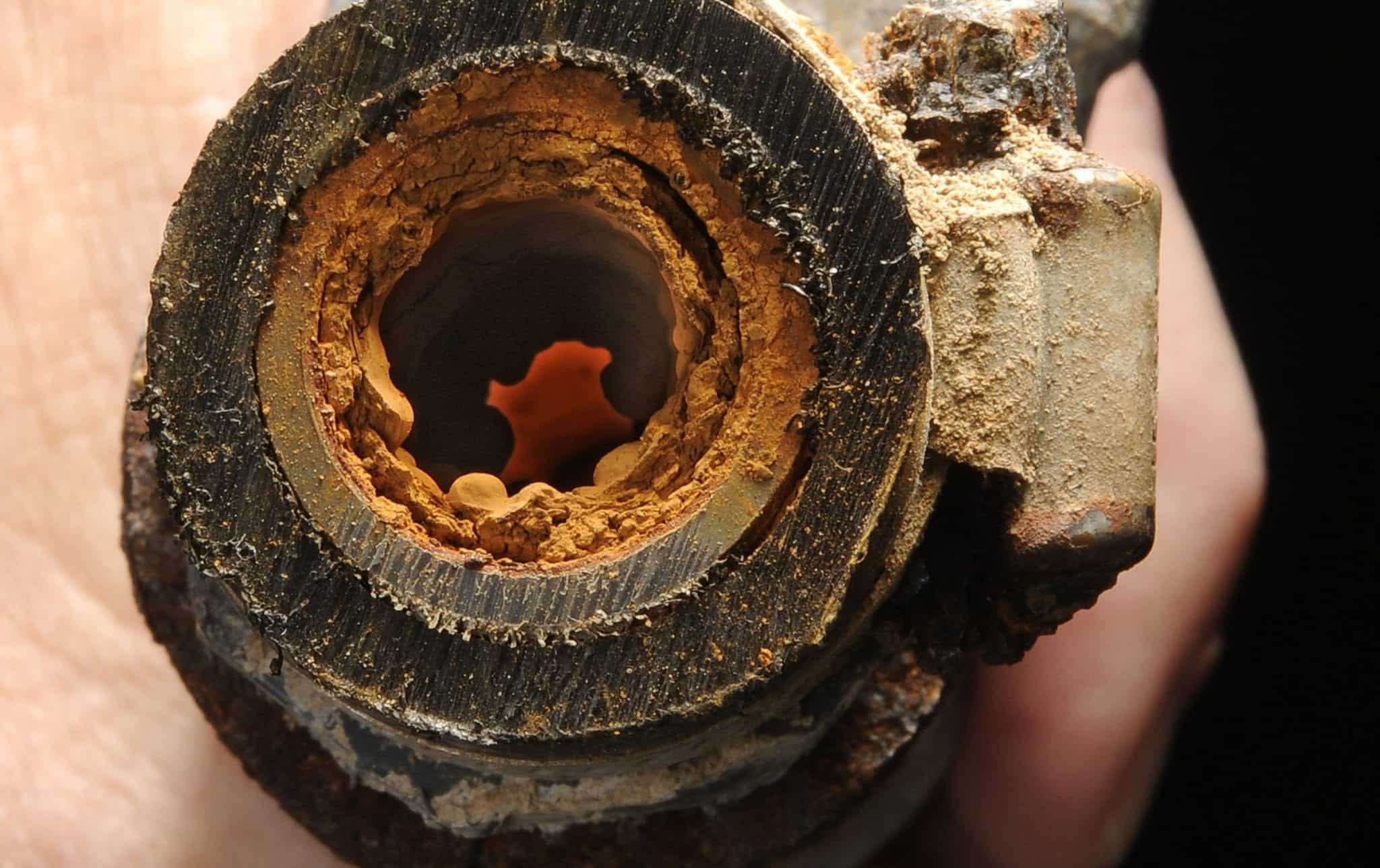 Pipe_with_iron_deposits_2 cropped close-up of rusty build-up on interior of corroded pipe
