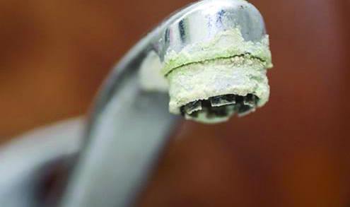 crusty calcium buildup corrosion on sink faucet