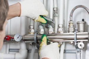 shutterstock_472141300 a plumber twisting screws