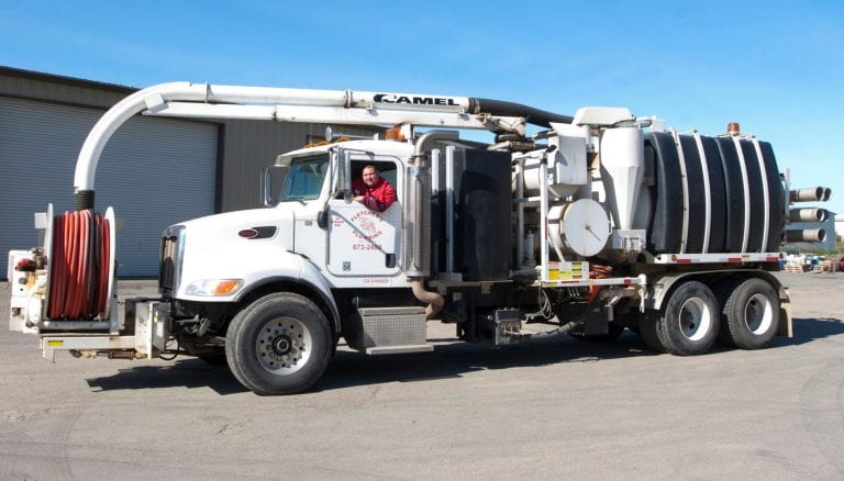 Fletcher's Plumbing camel vac truck in yard