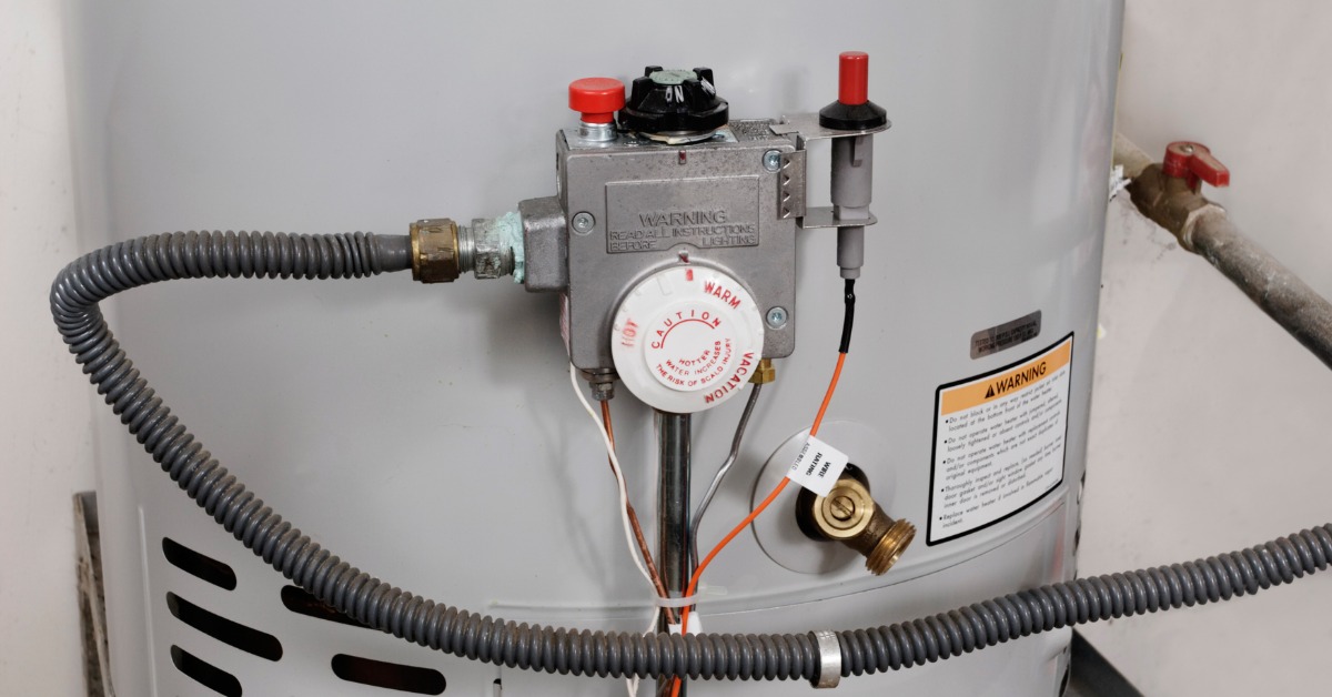 A water heater with a temperature adjustment dial that is connected to a valve to pump water into the house.
